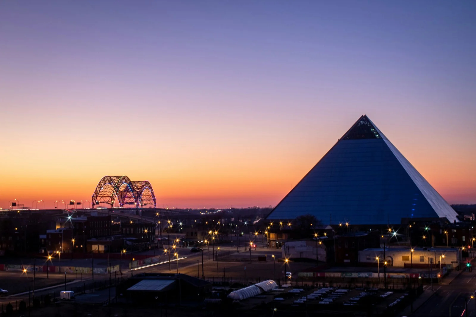 Memphis Pyramid and Hernando de Soto Bridge at sunset in Memphis, Tennessee